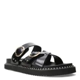 Sandalias planas Miss Carol Zelv de color negro, con diseño de tiras anchas cruzadas y hebillas metálicas doradas. Posee suela chunky con costuras visibles alrededor de la plataforma.