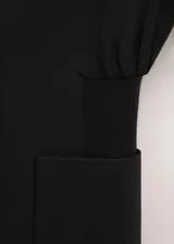 Blazer negro entallado de diseño largo con cuello de solapa y un solo botón de cierre. Cuenta con bolsillos frontales con solapa y una silueta entallada en la cintura.