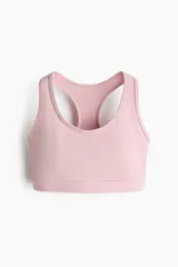 Top deportivo color rosado, con diseño de espalda nadadora y breteles anchos. Confeccionado en tejido funcional con tecnología SoftMove y DryMove, con soporte medio y elástico revestido en la base.