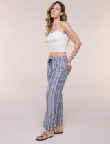 Pantalón de lino blanco, marca Dash, con pretina ancha elastizada, lazo de ajuste y bolsillos inclinados en el frente.