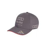 Gorra de béisbol gris con visera curva, detalle de borde rojo y logos bordados de Audi, Revolut y Adidas en color plateado.