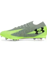 Championes de fútbol Under Armour Shadow Elite 3 FG, diseñados para velocidad y agilidad. Presentan una parte superior de tejido IntelliKnit gris con detalles en verde neón, logotipo de la marca en negro y suela exterior de fibra de carbono para máxima aceleración en superficies naturales.