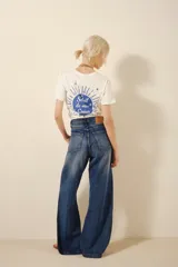 Pantalón de jean de tiro alto, corte ancho y pierna recta, con paneles de denim en tonos contrastantes.