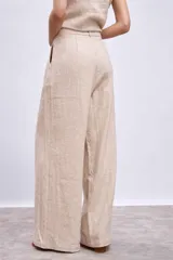Pantalón de lino color beige, de corte palazzo con pinzas en la cintura.