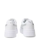 Championes Puma modelo Rebound Low con plataforma, color blanco con detalle de logo lateral en plateado metalizado. Diseño de caña baja con cordones y suela de goma gruesa.