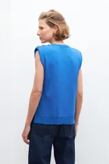 Top sin mangas de tejido liso, color azul francia, con cuello redondo y hombreras marcadas.
