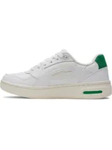 Championes Under Armour modelo W Flex, de diseño urbano en color blanco con detalles en verde. Presentan una parte superior de cuero premium, panel de talón acanalado y suela de goma con entresuela de EVA para mayor amortiguación.