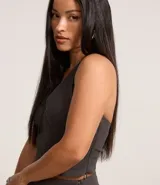 Blusa corta de bengalina negra con frente único, breteles anchos, recorte en el busto y cierre con botones en el cuello.