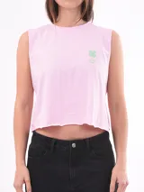 Remera sin mangas, color rosa claro, con cuello redondo y dobladillo inferior con terminación deshilachada. Presenta un pequeño estampado de trébol de cuatro hojas en color verde menta con texto debajo.