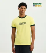 Remera de algodón color amarillo con cuello redondo y mangas cortas con bies en color verde oscuro. Presenta estampado frontal con la palabra Brasil en tipografía lineal.