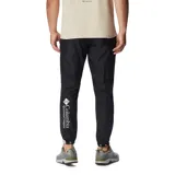 Pantalón deportivo de hombre, color negro, diseñado para actividades al aire libre. Presenta cintura elástica con ajuste, bolsillos laterales con cierre y puños elásticos en los tobillos. Confeccionado con tecnología repelente al agua y resistente a las manchas.