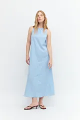 Maxi vestido celeste con rayas verticales blancas, cuello halter y lazo ajustable en la cintura.