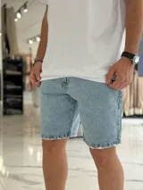 Bermuda de jean de corte slouchy en color celeste claro, con efecto deslavado y detalles de roturas sutiles en los dobladillos.