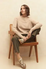 Polera de cuello redondo tejida en color marrón, con detalle de textura en el canesú y puños elastizados.