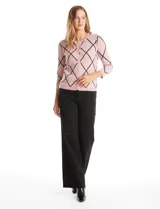 Cardigan de punto con diseño de rombos en color rosa y líneas negras. Presenta cuello redondo, cierre frontal con botones metálicos y mangas tres cuartos.