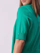 Bolero tejido color fucsia, marca Ninety, de manga corta con apliques de botones.