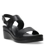 Sandalias de plataforma con diseño ergonómico, color negro, con tiras ajustables con velcro y textura grabada en la tira delantera.