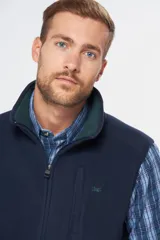 Chaleco deportivo rojo de polar con forro e interior en color azul combinado, cierre frontal y bolsillos delanteros con cierre metálico personalizado. Incluye dos bolsillos interiores con cierre y logo bordado en el pecho.