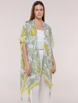 Kimono de gasa ligera con estampado floral en tonos beige y salmón, de silueta amplia, mangas cortas integradas y ruedo asimétrico con detalles de borlas en las puntas.
