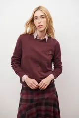 Sweater de punto color bordó, con cuello redondo y logo bordado en el pecho.