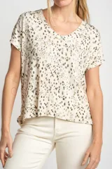 Remera color crema con estampado de manchas marrones, de corte oversize, con cuello en V y mangas cortas.