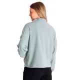 Buzo polar celeste de corte holgado, con cuello alto con cierre de media cremallera azul y logo de la marca bordado en el pecho.