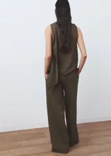 Pantalón de corte recto y pernera ancha, color verde militar con sutiles rayas verticales. Cuenta con cintura elástica con cordón ajustable y bolsillos laterales.