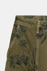 Jeans de tiro bajo y diseño barrel leg de la colección Zara Woman, en color verde militar con estampado floral en contraste, trabillas para cinturón y costuras decorativas frontales.