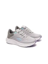 Championes de running Umbro modelo Icon, color azul con detalles en naranja y suela blanca. Presentan una combinación de malla transpirable y refuerzos sintéticos, con el logo de la marca en el lateral.