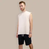 Musculosa beige de algodón con efecto acid wash y corte holgado.