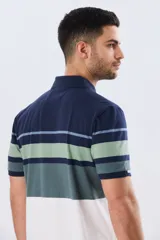 Remera polo de manga corta con diseño de franjas horizontales en tonos azul, salmón, celeste y beige. Cuenta con cuello clásico y cierre frontal de dos botones.