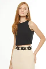 Cinto negro de cuero sintético con apliques de perlas sintéticas y detalles metálicos dorados.