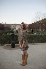 Botas de caña alta desmontables que se transforman en botinetas, confeccionadas en gamuza color beige. Presentan un diseño de punta semicuaadrada, taco cuadrado de 6 cm y detalle de estribo con hebilla forrada en el tobillo.