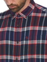 Camisa de manga larga Original Penguin con estampado a cuadros en tonos azul marino, rojo y blanco. Presenta cuello abotonado, bolsillo en el pecho con el logo bordado y corte clásico.