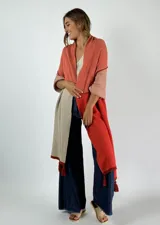 Pashmina de algodón con diseño color block en tonos naranja, coral y beige, con flecos decorativos en los extremos.