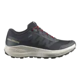 Championes de trail running Salomon Vision color gris oscuro, con detalles en rojo en los cordones, suela blanca y amortiguación texturizada.