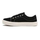 Championes casual de lona color negro con suela plataforma blanca acanalada. Presenta costuras decorativas en hilo blanco contrastante y ojales metálicos blancos.