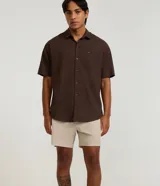 Bermuda playera masculina de corte básico, confeccionada en microfibra texturizada. Presenta cintura elástica con cordón ajustable y bolsillos laterales.