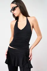 Top negro con escote halter y espalda descubierta.