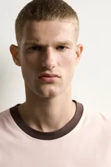 Camiseta de corte regular fit en color rosado, con cuello redondo y mangas cortas en color marrón oscuro a contraste.