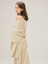Chal de punto color beige con textura acanalada y sutil brillo metalizado.