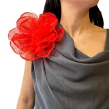 Broche en forma de flor grande confeccionado en organza de color rojo intenso, con pétalos superpuestos que crean volumen.