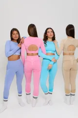 Conjunto deportivo de dos piezas compuesto por un top de manga larga con cuello redondo y calzas de tiro alto. Ambas prendas presentan un diseño seamless con detalles de textura en relieve y un acabado jaspeado en color azul cielo.