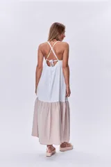 Maxi vestido blanco con corte debajo del busto y falda larga color beige.