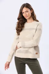 Buzo tejido de punto en jacquard color beige claro con estampado en tonos grises, de cuello redondo y manga larga.