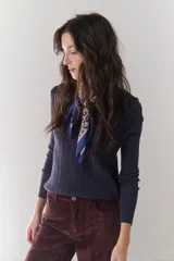 Sweater azul marino de tejido de punto acanalado con escote en V y mangas largas.