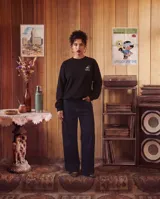 Buzo de cuello redondo color negro, con estampado gráfico en la espalda que representa un llavero con la inscripción KABOA INDUSTRIES. Presenta un corte regular con puños y cintura acanalados.