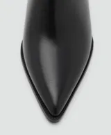 Botín de tacón bloque y punta fina, con cierre de cremallera lateral y acabado efecto piel.