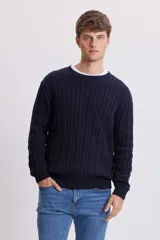 Buzo de punto con diseño de ochos, color azul marino, con cuello redondo y puños y ruedo acanalados.