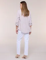 Camisa de lino de la marca Dash, color beige con rayas verticales blancas. Cuenta con cuello camisero, cierre frontal con botones, un bolsillo aplicado en el pecho y mangas largas con sistema de ajuste para arremangar.